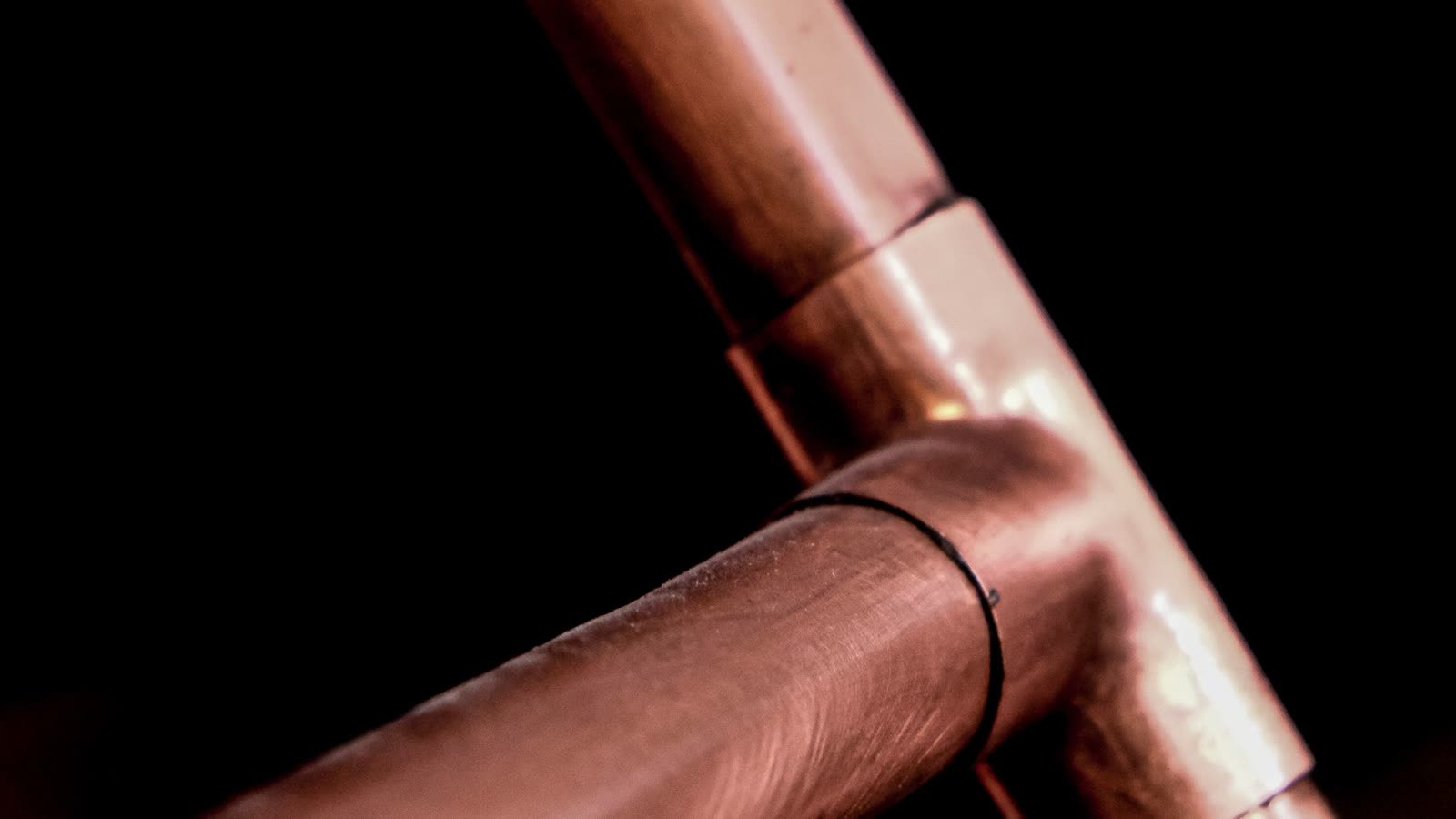 Close-up of copper tube and a soldered elbow joint. Copper is the material used in removable coils; the tube is joined by soldering and wound so it can be withdrawn from the body